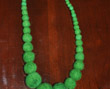 Long strand of graduated-size green felt beads